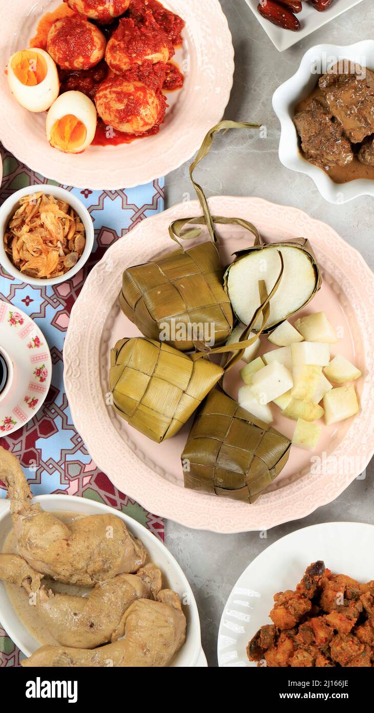 Ketupat Lebaran. Traditional Celebratory Dish of Rice Cake or Ketupat with Various Side Dishes, Popular Served During Eid Celebrations. For Social Med Stock Photo