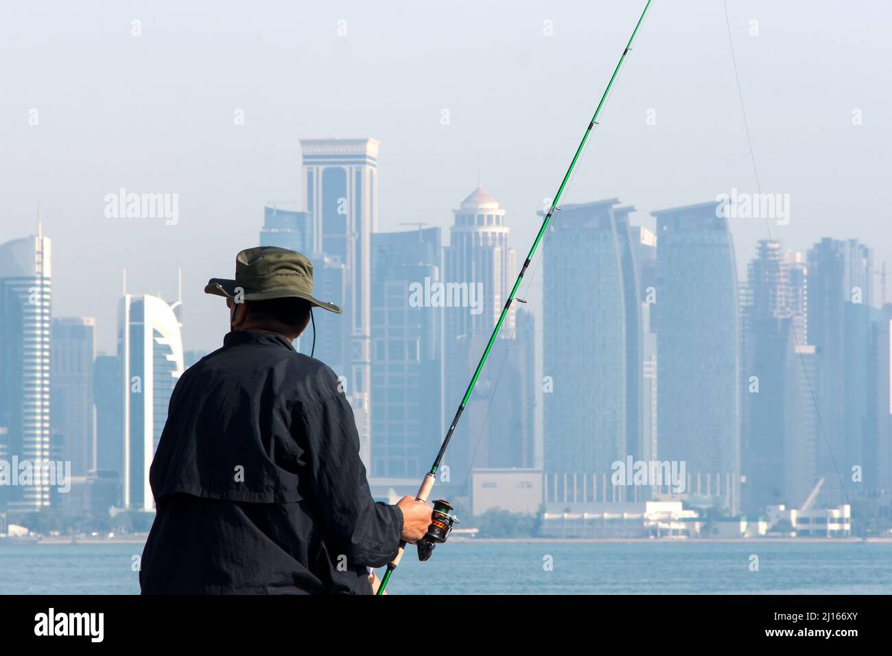 A man fishing on the dock in Doha, Qatar Stock Photo