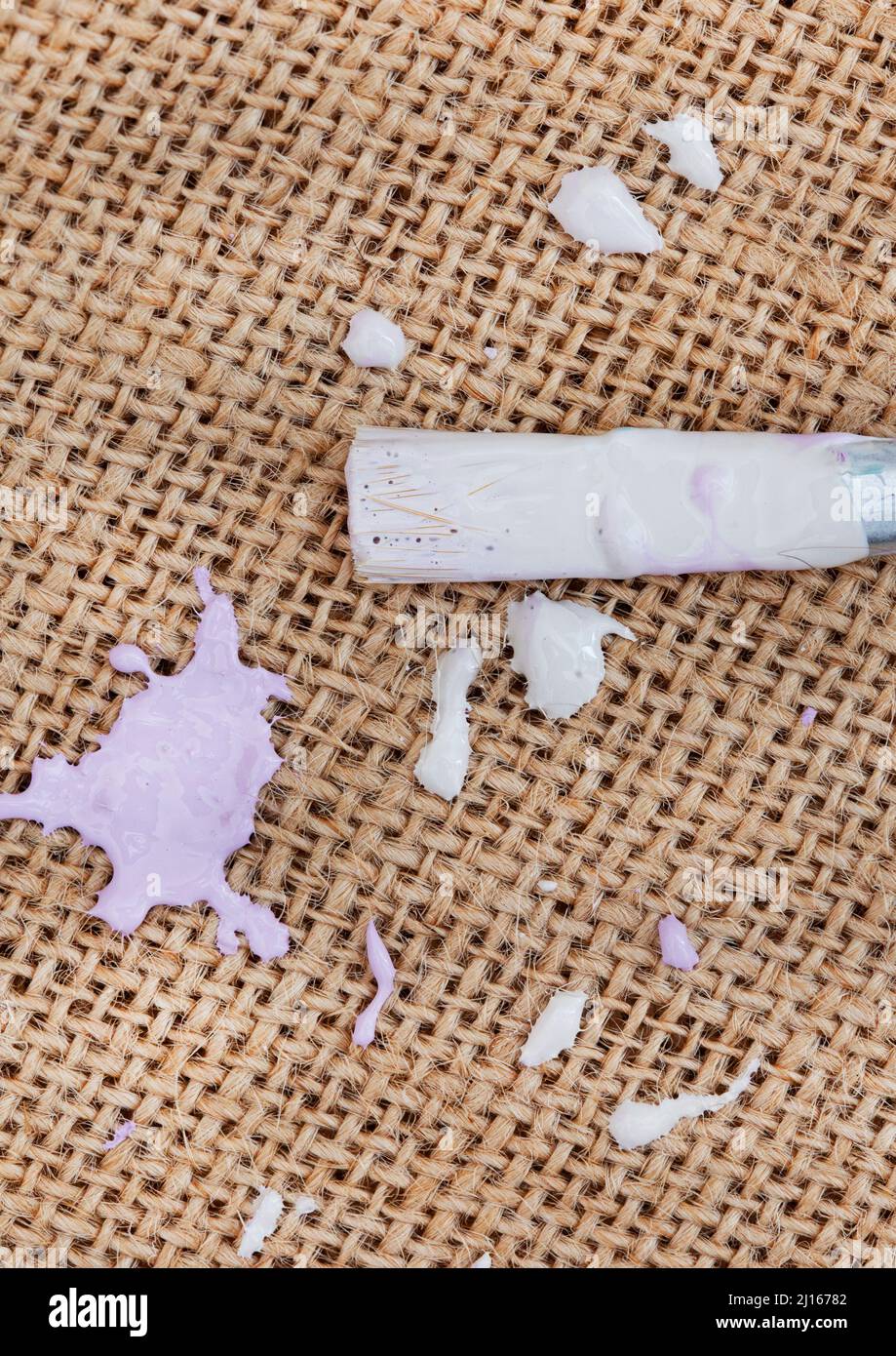 rustic hessian surface with pastel paint splatter and craft supplies ...