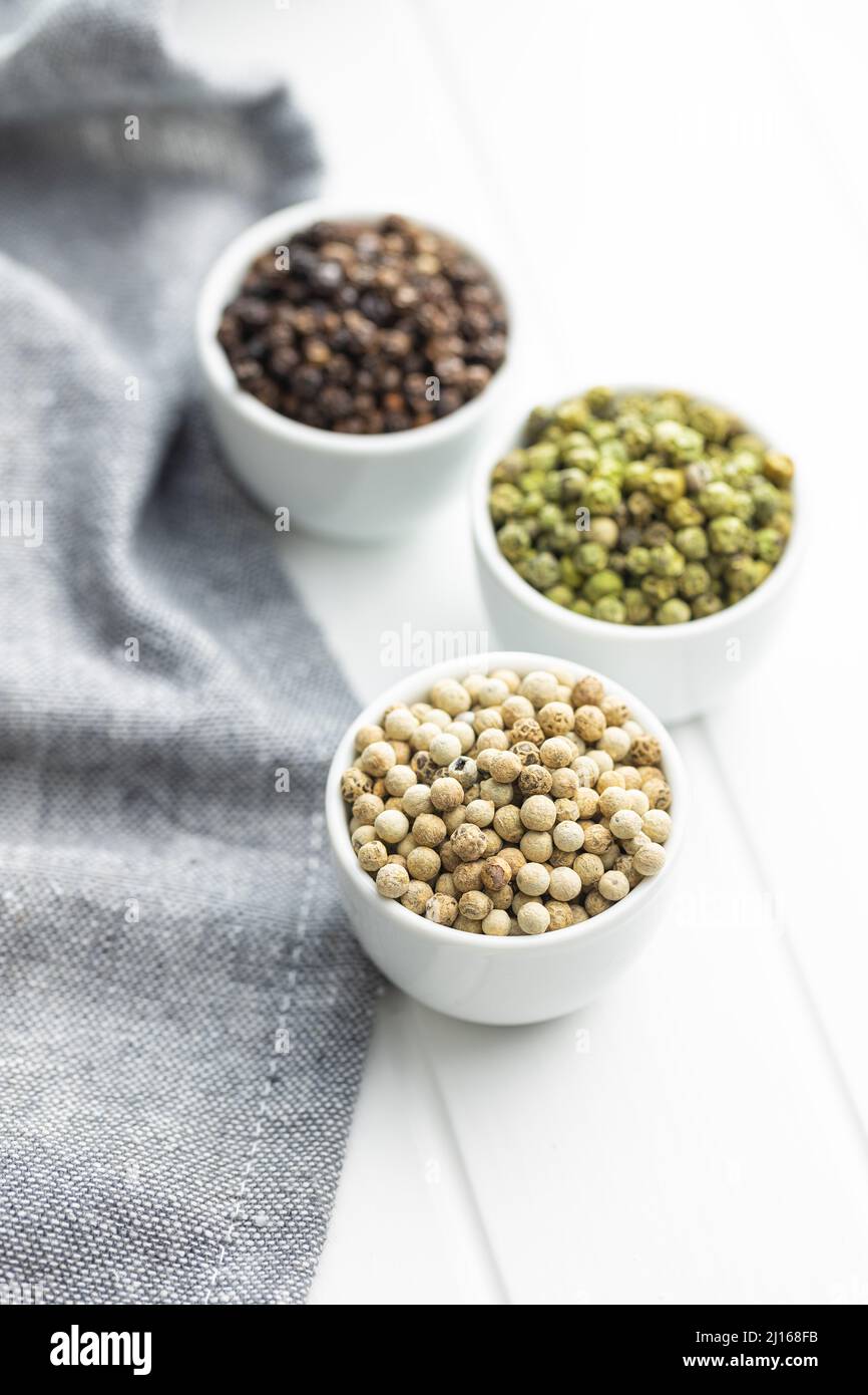 Three different types of pepper spice. Green, white and black