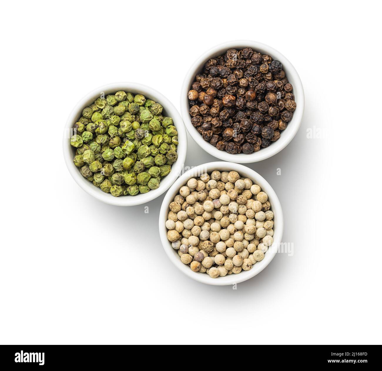 Three different types of pepper spice. Green, white and black peppercorn in the bowls. Top view. Stock Photo