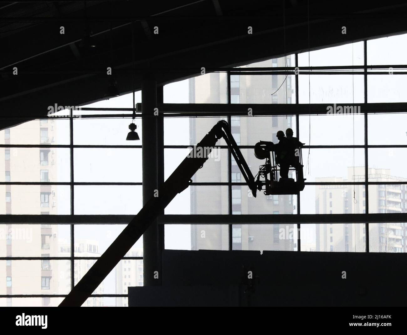 Shenyang, March 22. 20th Mar, 2022. Staff members work at the construction site of the temporary hospital at Shenyang International Exhibition Center in Shenyang, northeast China's Liaoning Province, March 22, 2022. The temporary hospital and health station at Shenyang International Exhibition Center started construction on March 20, 2022. Credit: Yang Qing/Xinhua/Alamy Live News Stock Photo
