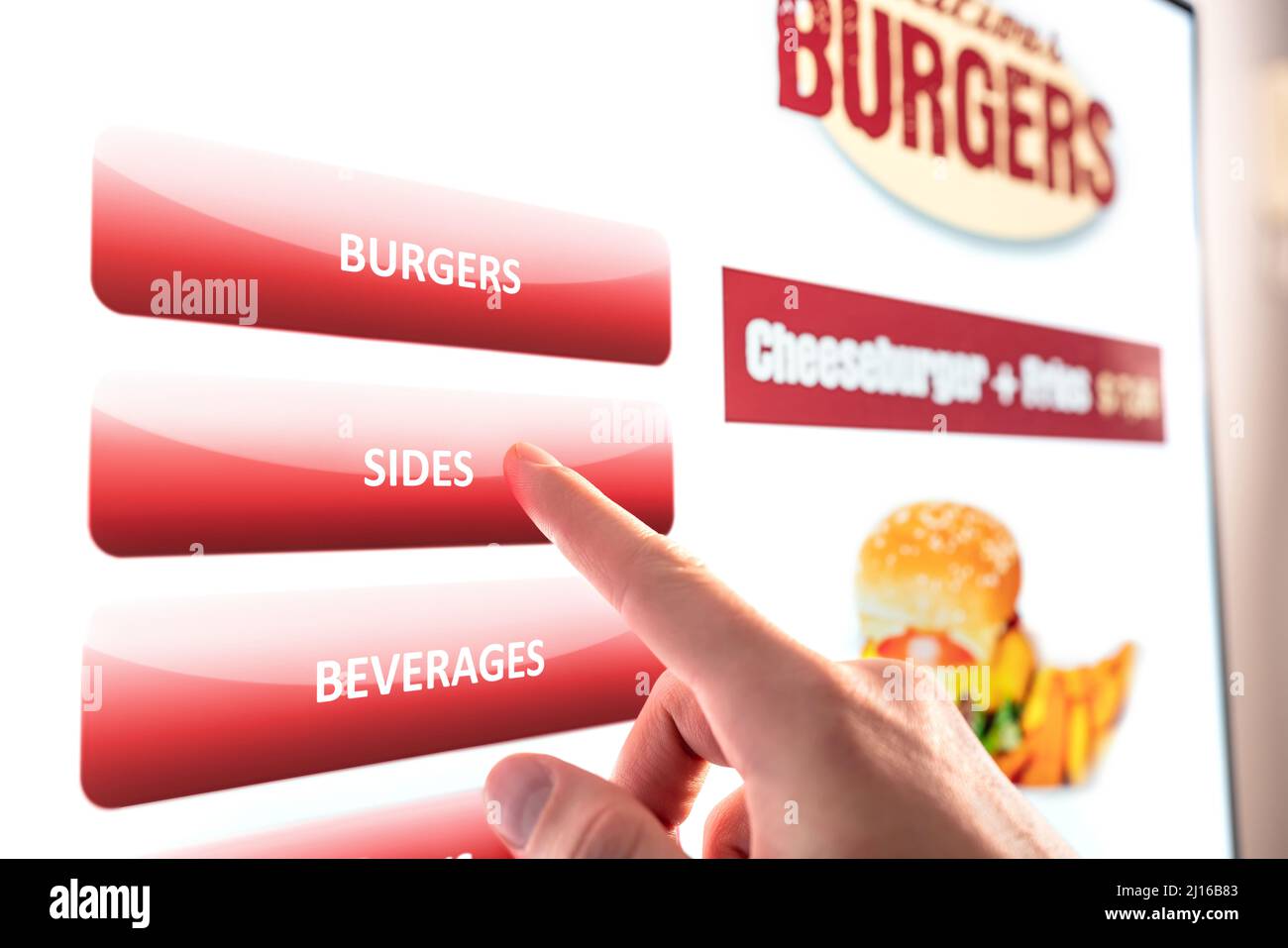 Self service and order kiosk in restaurant. Fast food touch screen, digital vending machine. Man using electronic menu and buying burger meal. Stock Photo