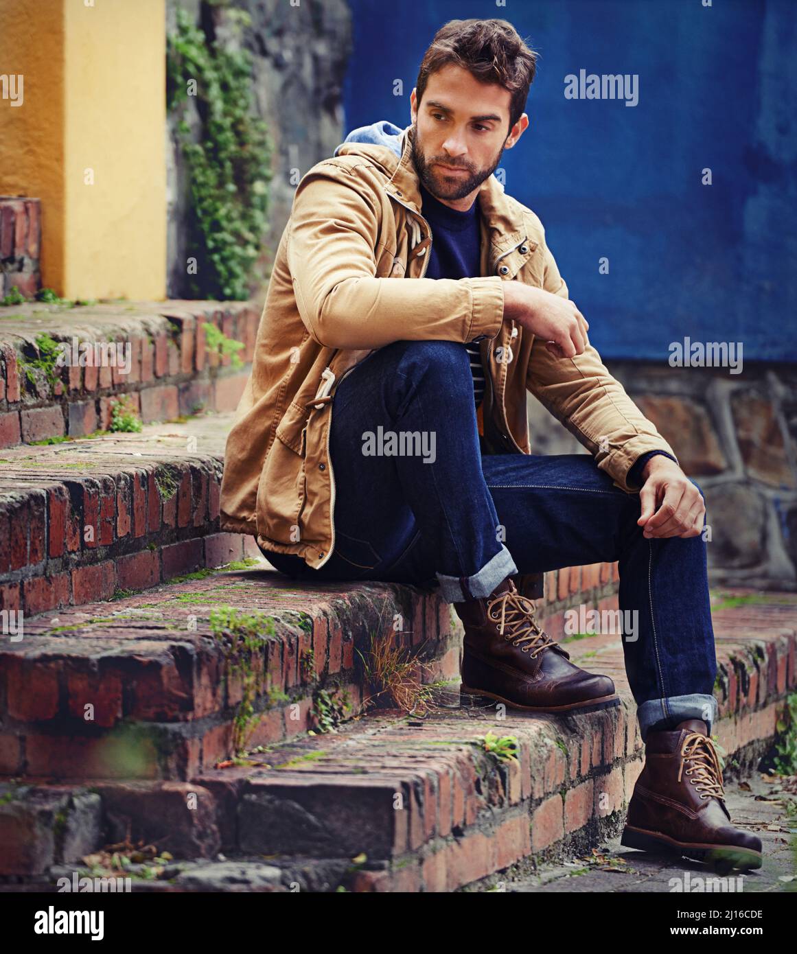 The steps to a good wardrobe. A handsome young man in winter attire