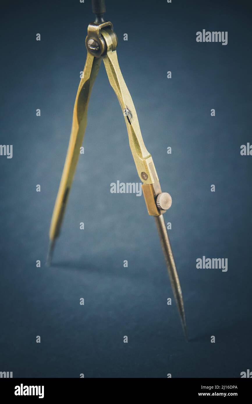 Old vintage pair of compasses on a dark background Stock Photo