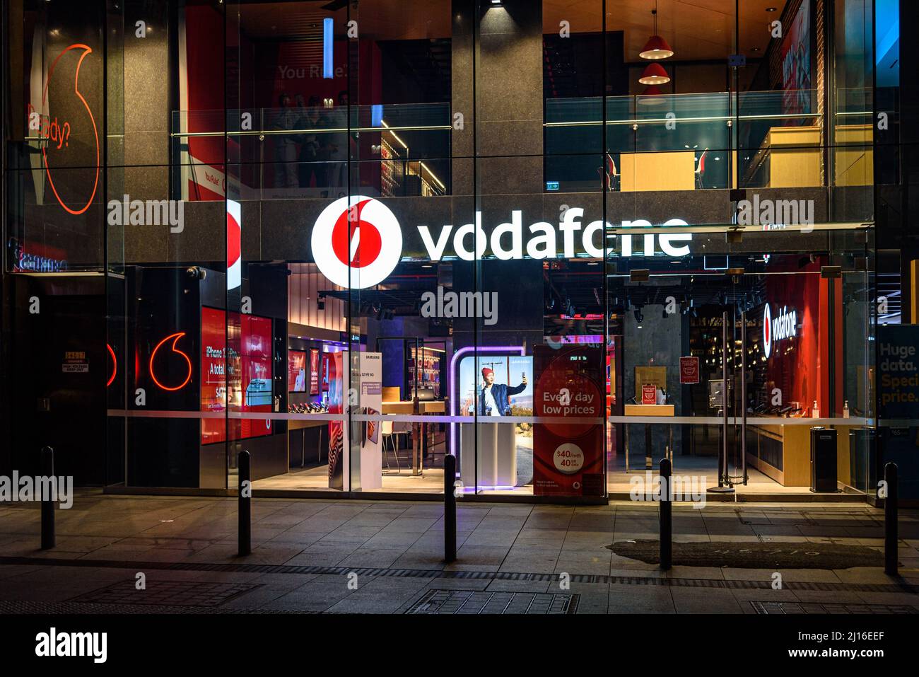 A Vodafone store on Street in Sydney, Australia at night Stock