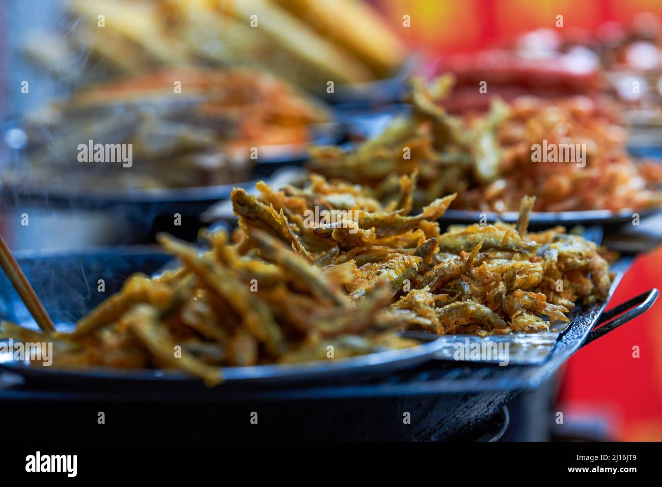 Beachside street food, fried small crabs and fried sea fish Stock Photo