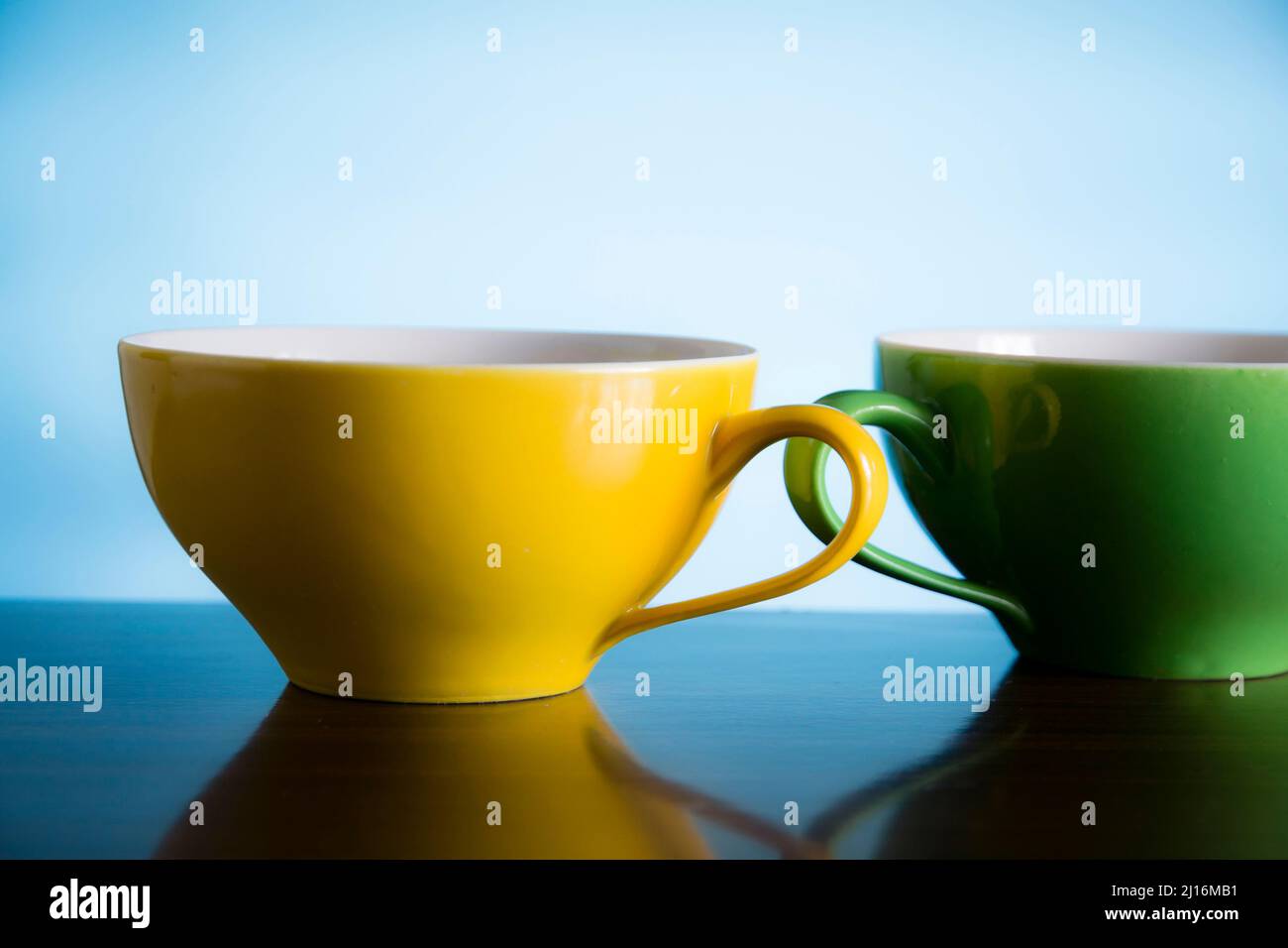 yellow and green tea cups Stock Photo - Alamy