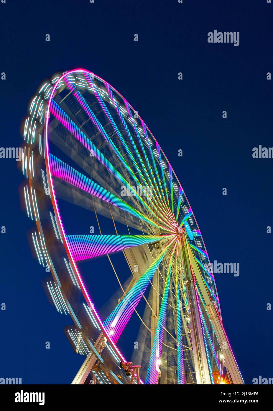 huge colorful ferriswheel rotating in a blue summer night Stock Photo
