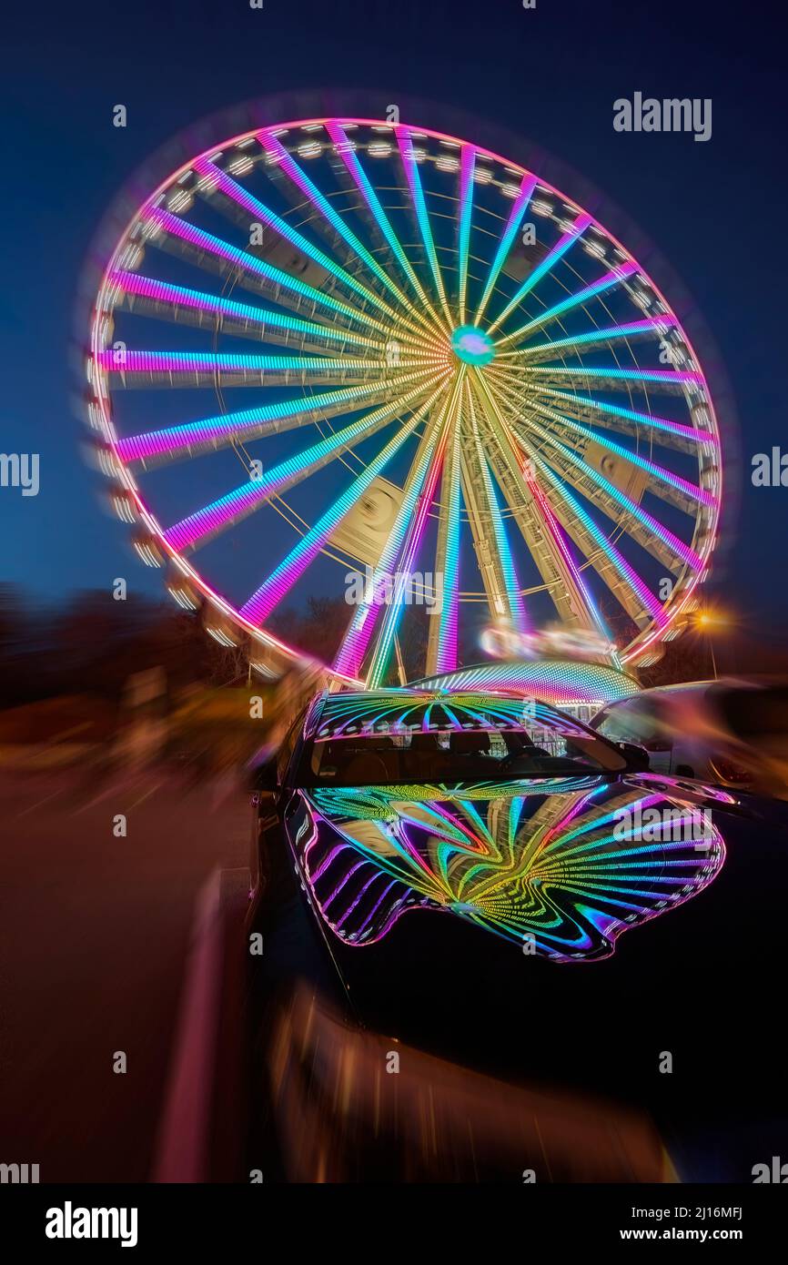 huge colorful ferriswheel rotating in a blue summer night Stock Photo