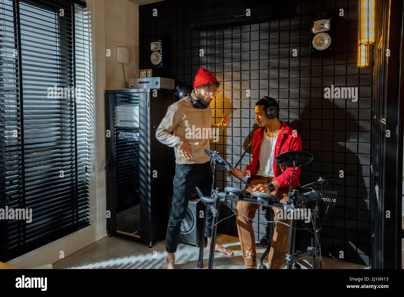 Men playing electric drums at home studio Stock Photo