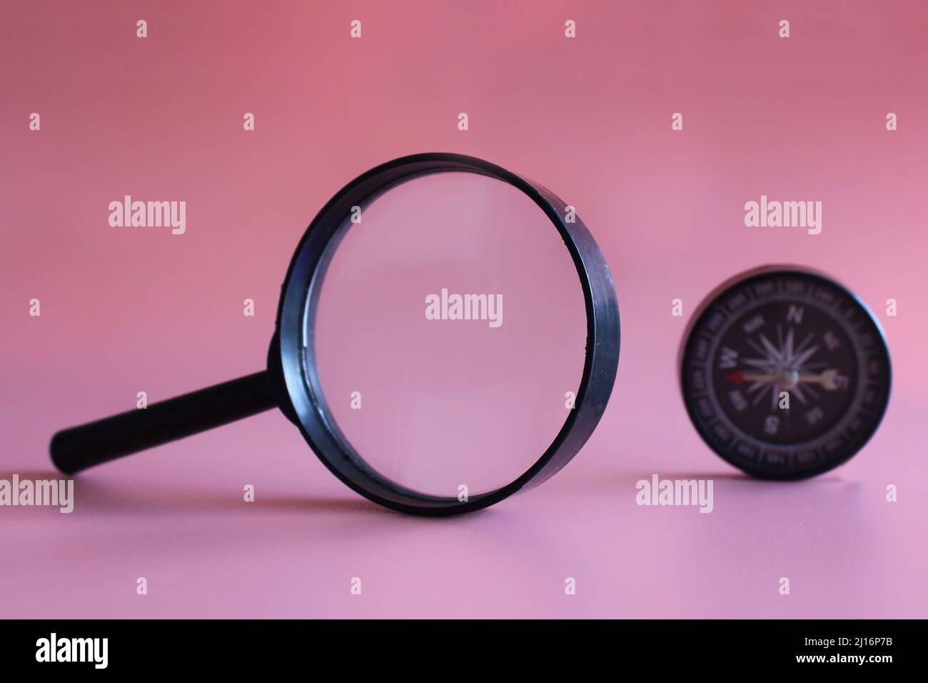 Magnifying glass and compass. Looking for direction and guidance