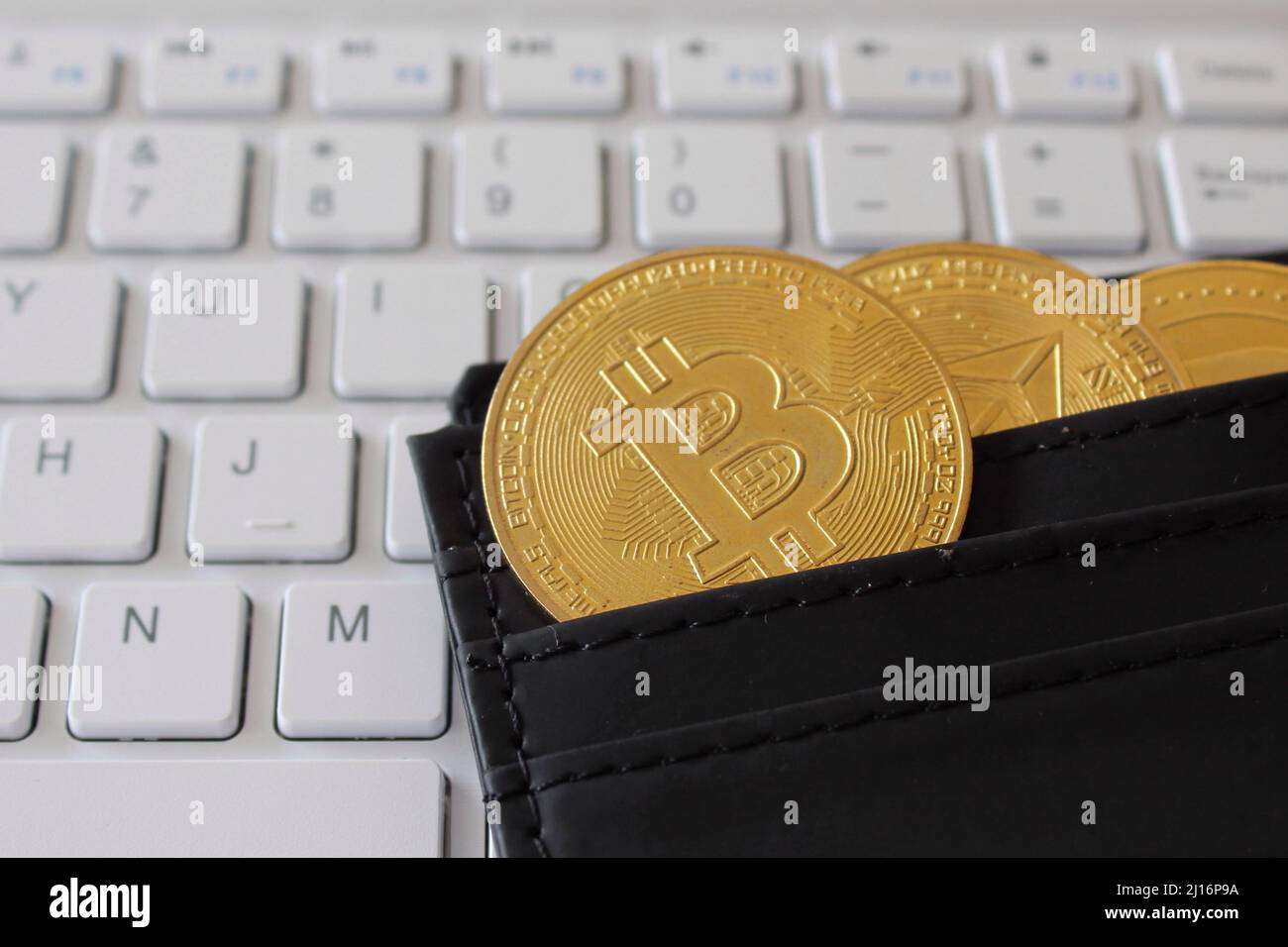 Bitcoin, wallet and computer keyboard. Cryptocurrency, digital wallet, e-wallet concept. Stock Photo