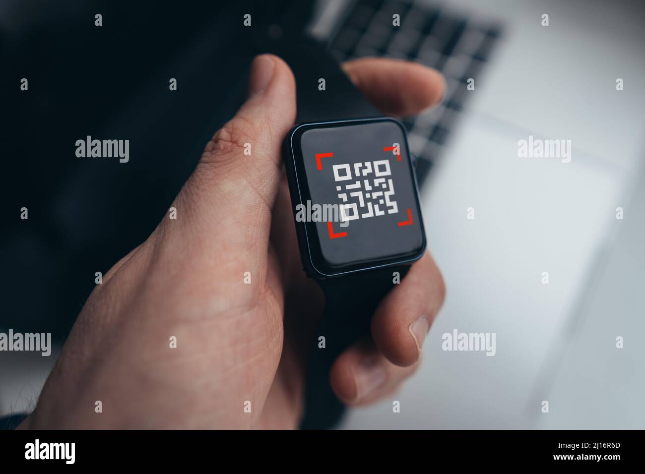 QR code concept. Clock with a symbol on the screen in the hands of the