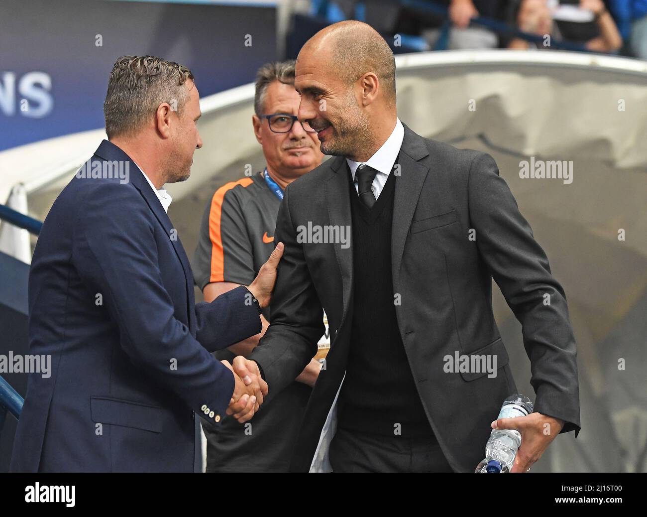 MANCHESTER, ENGLAND - AUGUST 24, 2016: City manager Josep Guardiola (R) greets FCSB head coach Laurentiu Reghecampf (L) prior to the second leg of the 2016/17 UEFA Champions League tie between Manchester City (Engalnd) and FCSB (Romania) at Etihad Stadium. Copyright: Cosmin Iftode/Picstaff Stock Photo