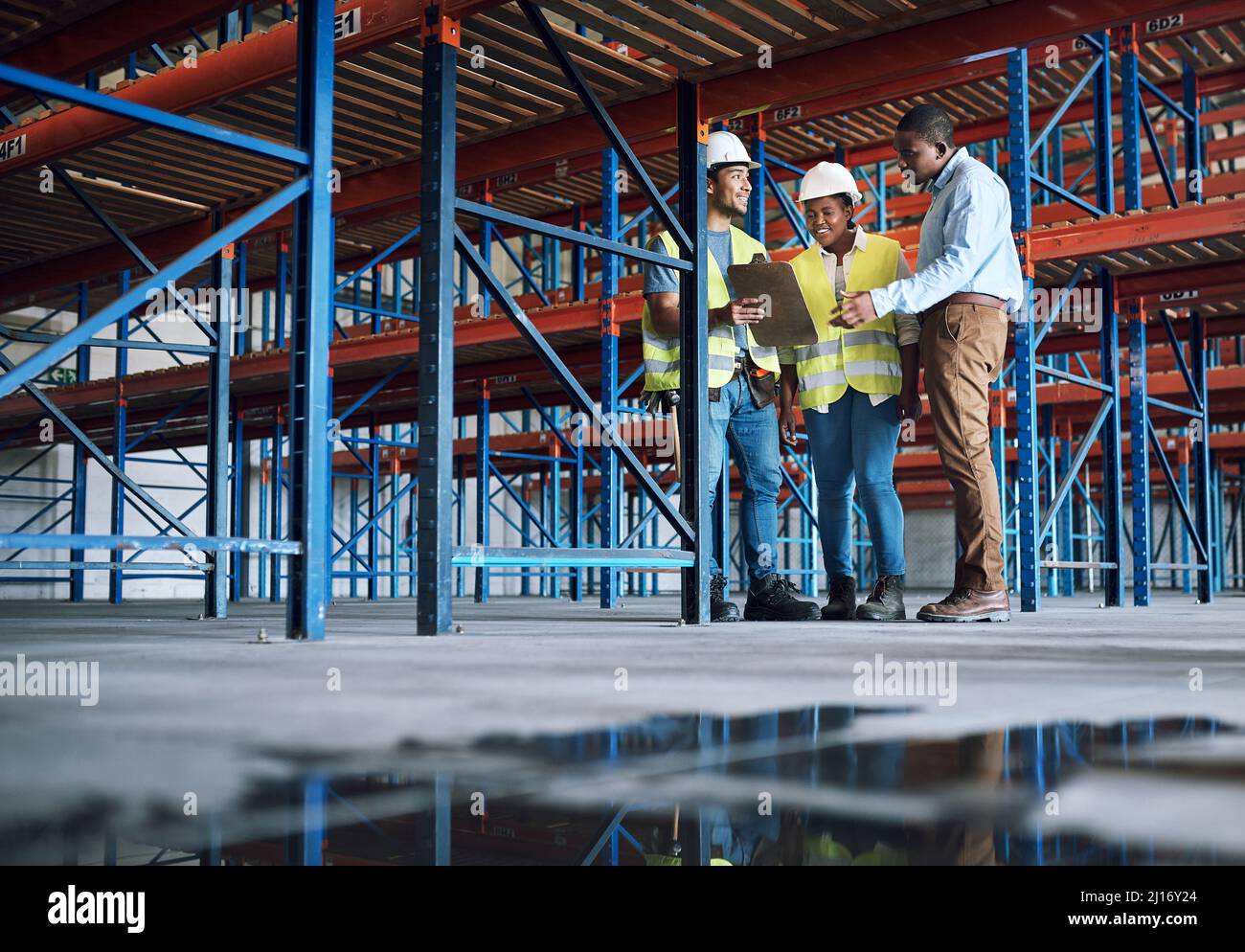 They dont just design the future, they enhance it. Shot of a group of builders inspecting a construction site. Stock Photo