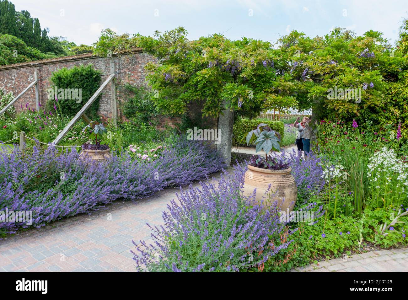 Entering the Sundial Garden through stone pillars festooned with