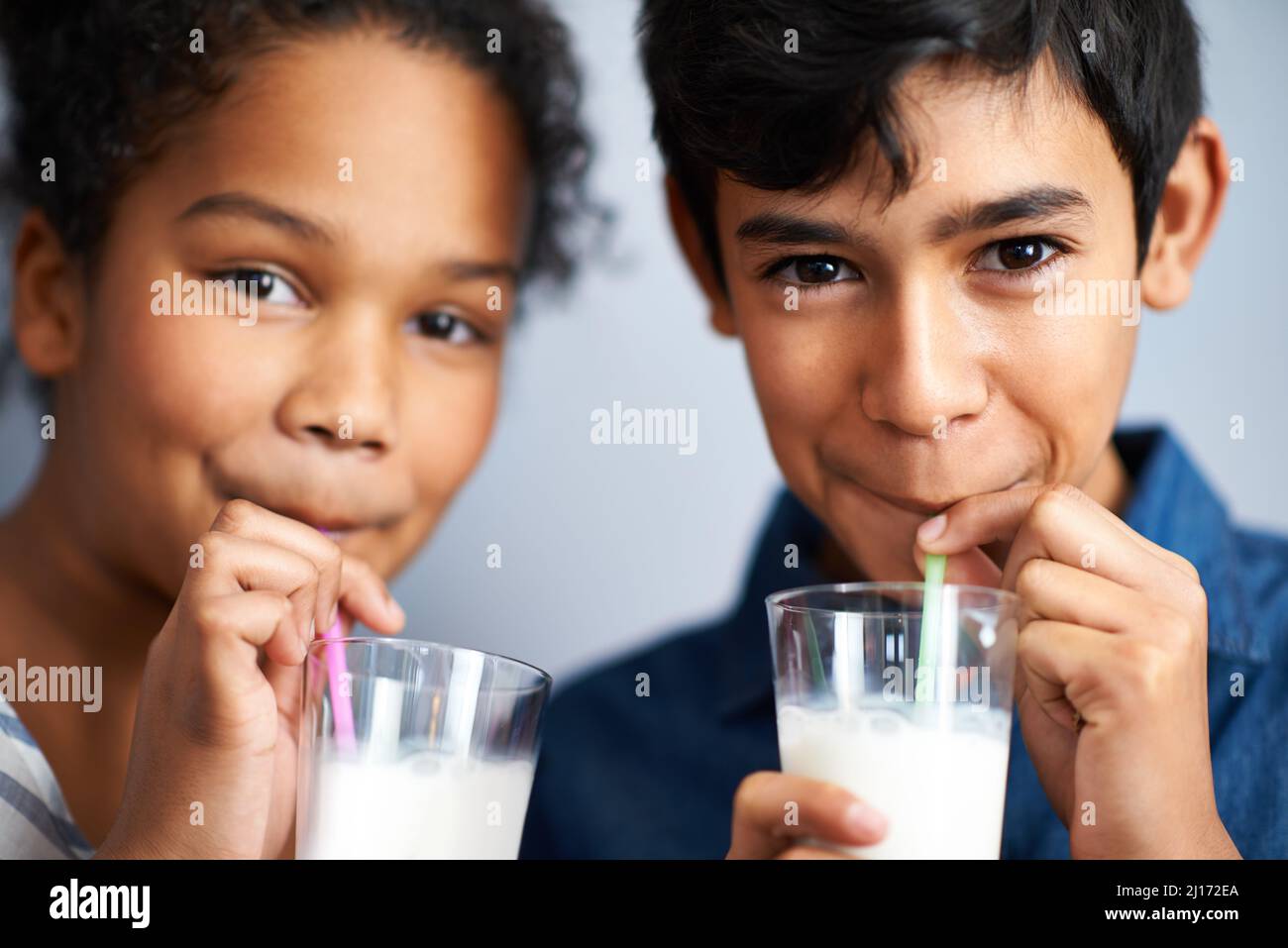 Calcium for healthy bones. A brother and sister drinking milk together. Stock Photo