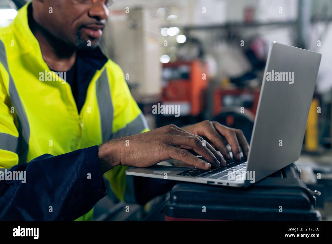 Factory worker working with laptop computer to do adept procedure checklist . Factory production line operator occupation quality control concept . Stock Photo