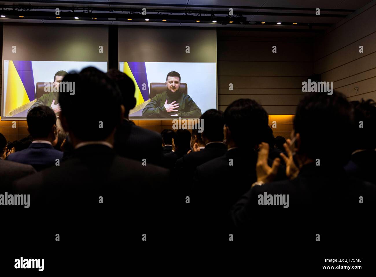 Tokyo, Japan. 23rd Mar, 2022. Members of the Japan's lower house parliament applaud at the end of Ukrainian President Volodymyr Zelensky speech via videolink at the House of Representatives office building in Tokyo on March 23, 2022. (Credit Image: © POOL via ZUMA Press Wire) Credit: ZUMA Press, Inc./Alamy Live News Stock Photo