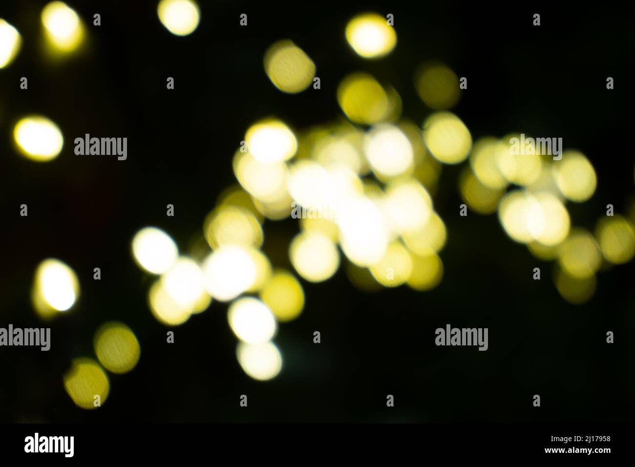 Random scattered bright yellow lights in abstract on black background