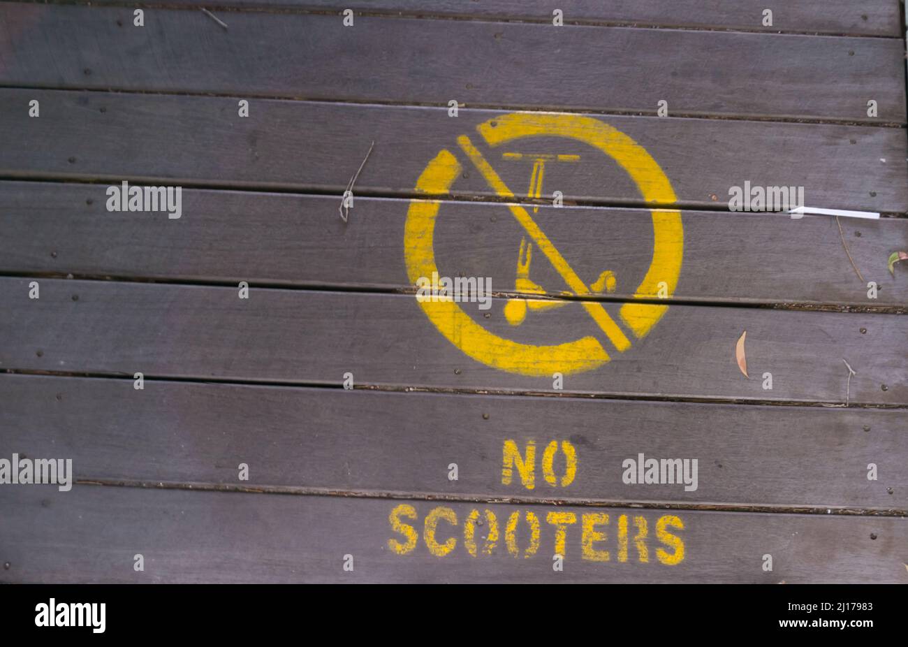 No scooters sign on wooden pathway in city Stock Photo