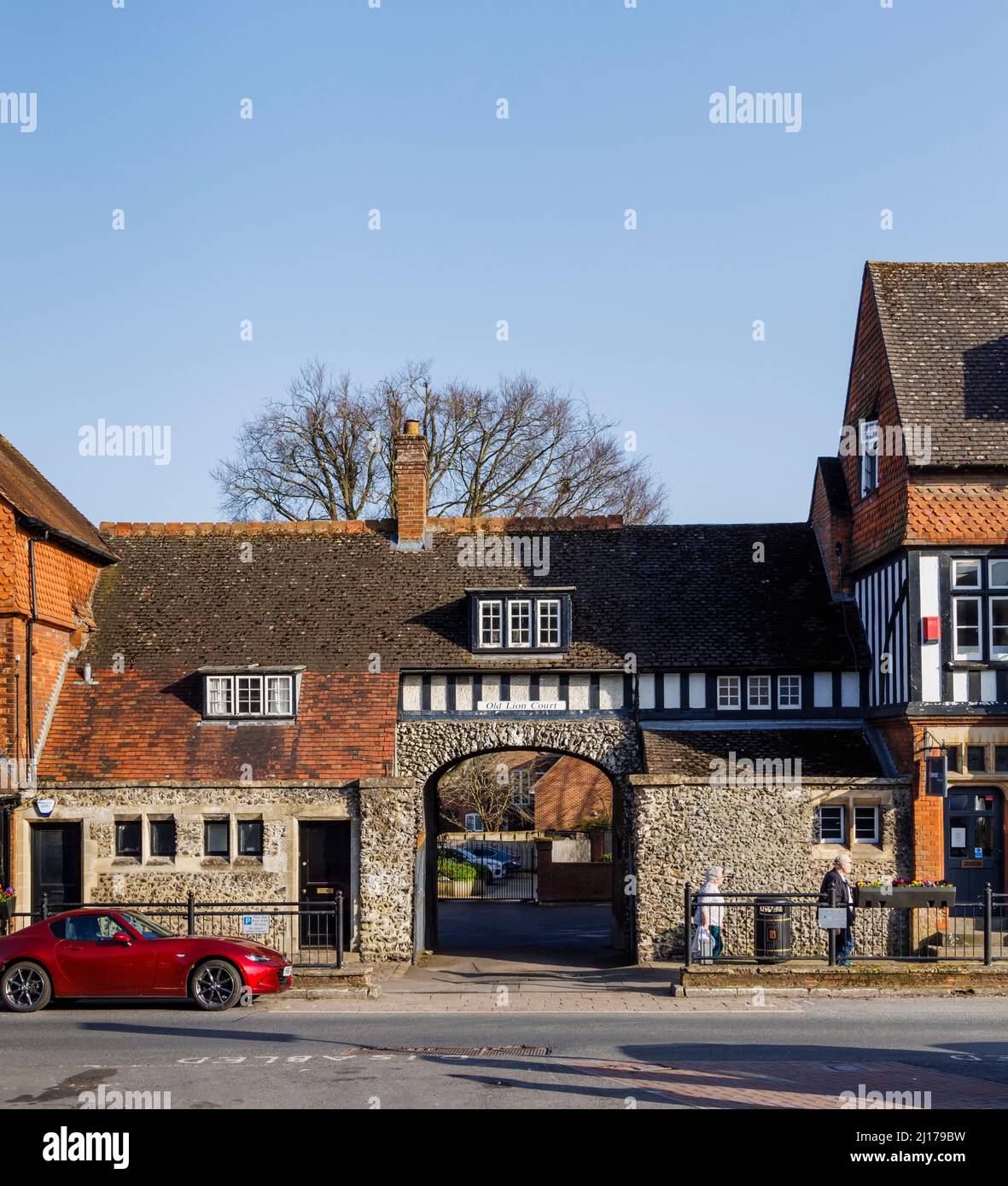 Entrance to Old Lion Court in High Street, Marlborough, a market town in Wiltshire, England on a sunny day with blue sky in late winter / early spring Stock Photo