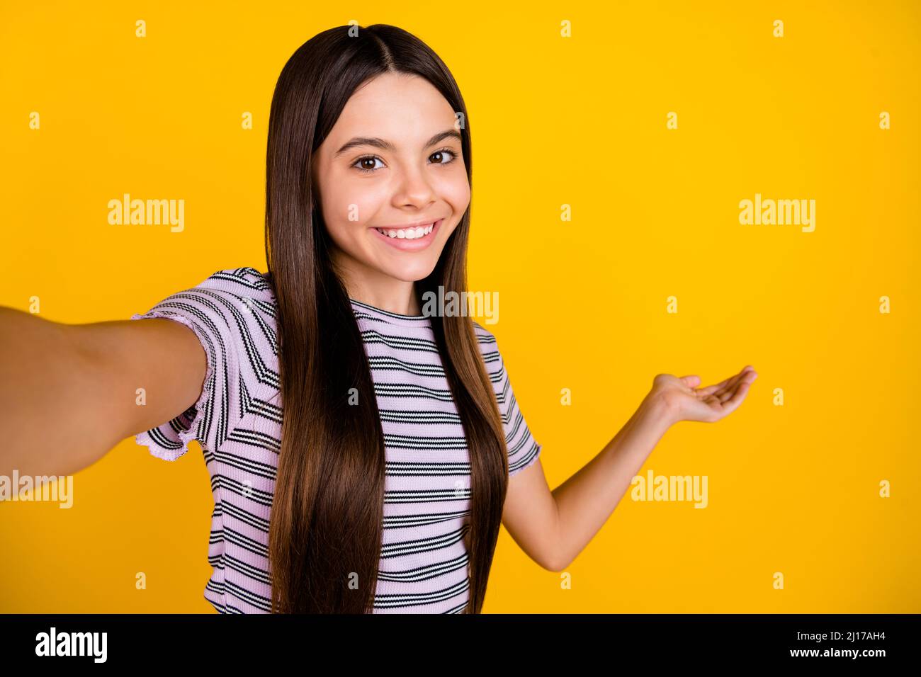 Photo of young pretty lady indicate hand empty space welcome video call  isolated over yellow color background Stock Photo - Alamy