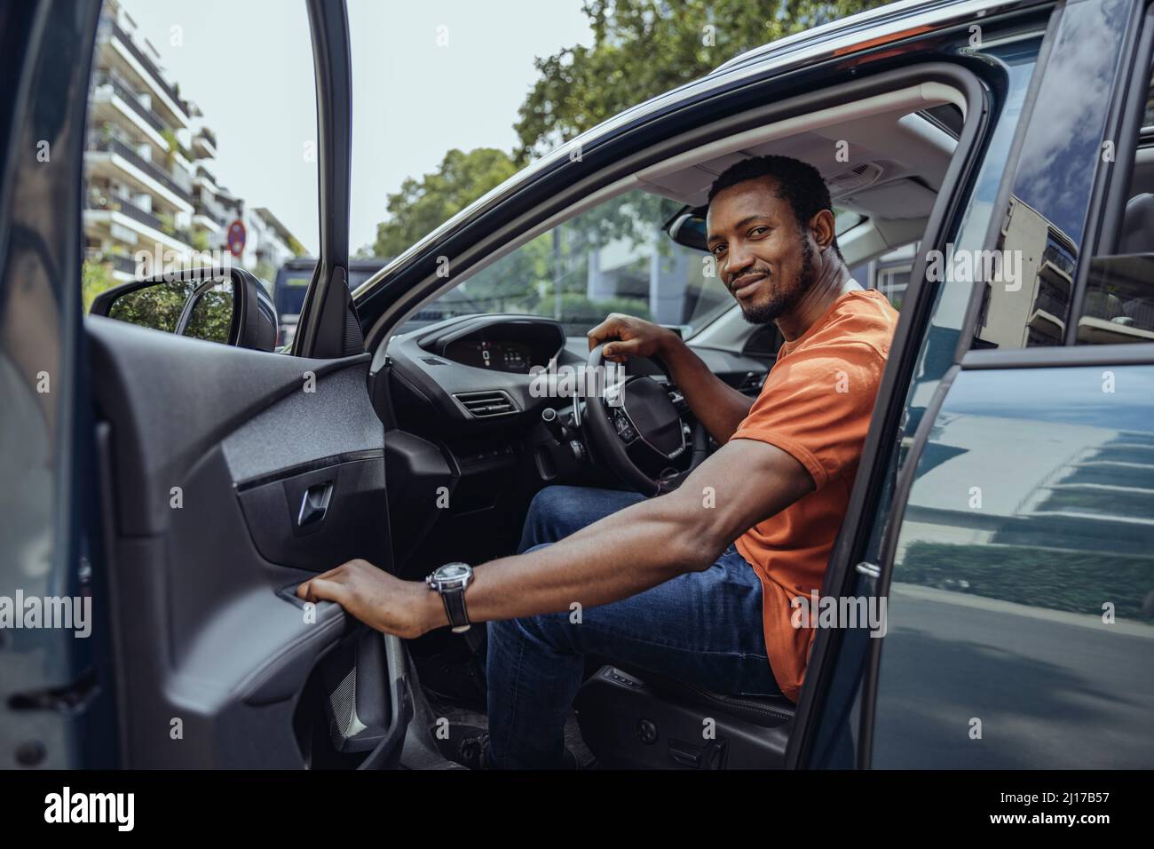 Man sitting on driver's seat in car Stock Photo Alamy