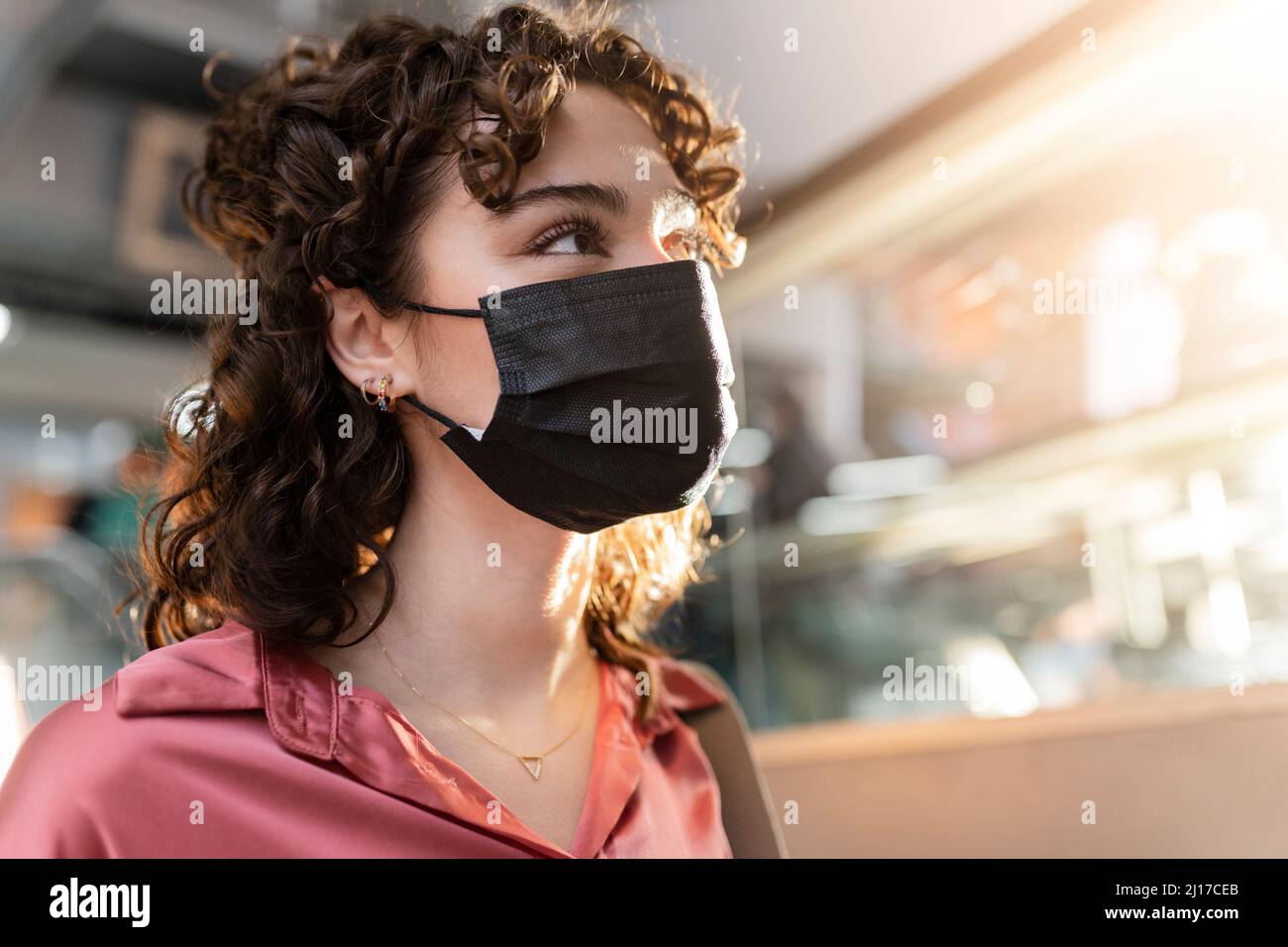 Young woman wearing protective face mask Stock Photo