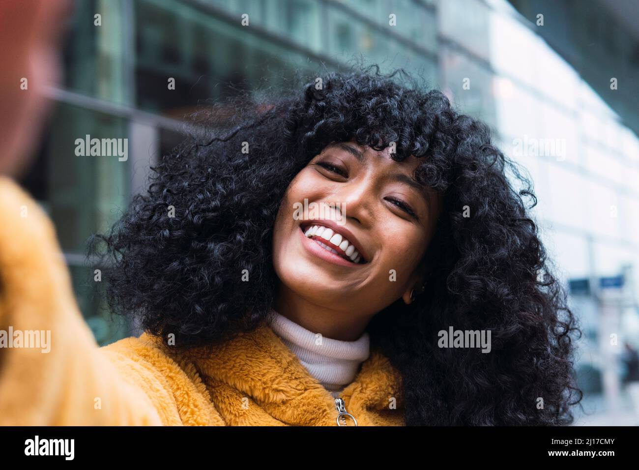 Cheerful young woman taking selfie Stock Photo