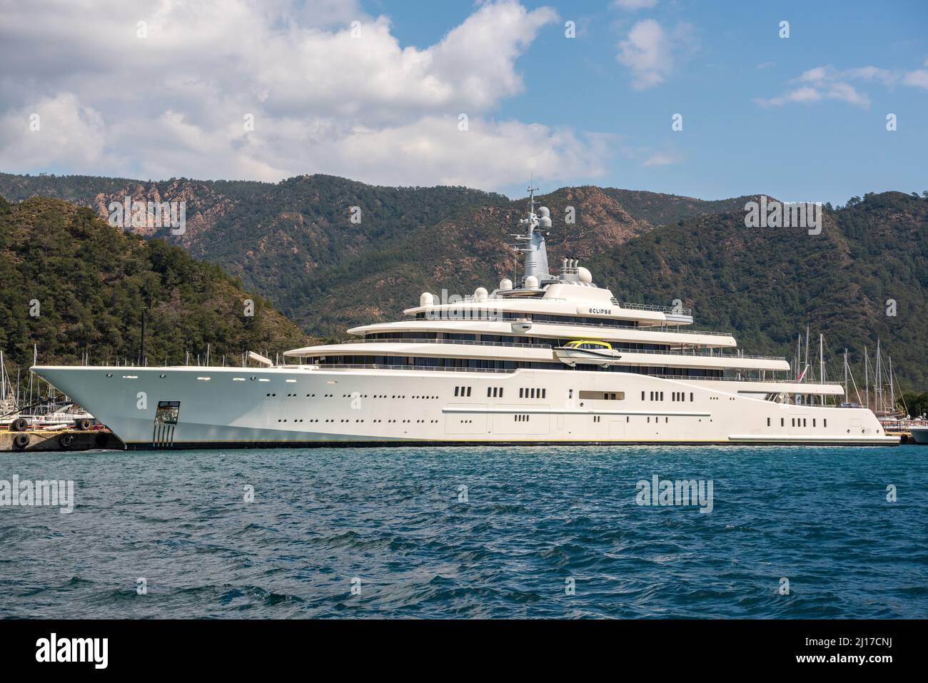 Marmaris, Turkey – March 23, 2022. M/Y Eclipse superyacht owned by  Russian oligarch Roman Abramovich, in Netsel Marina port of Marmaris, Turkey. Built by Blohm+Voss of Hamburg, Germany and delivered to Abramovich on 9 December 2010, the yacht is the fourth longest afloat. The yacht's cost has been estimated at €340 million. Eclipse has two helicopter pads, 24 guest cabins, two swimming pools, several hot tubs, and a disco hall. It is also equipped with three launch boats and a mini-submarine that is capable of submerging to 50 metres (160 ft). Stock Photo