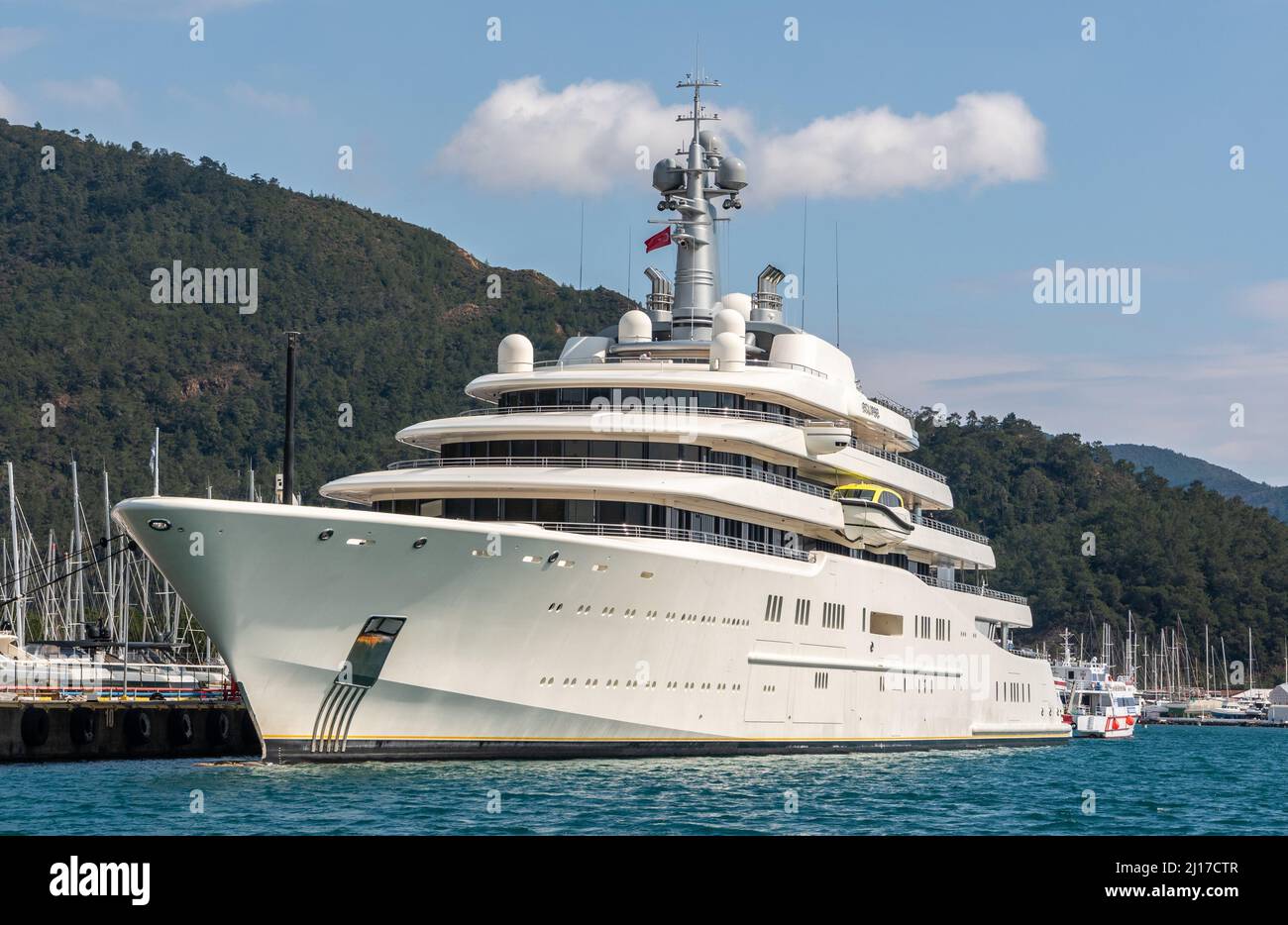 Marmaris, Turkey – March 23, 2022. M/Y Eclipse superyacht owned by  Russian oligarch Roman Abramovich, in Netsel Marina port of Marmaris, Turkey. Built by Blohm+Voss of Hamburg, Germany and delivered to Abramovich on 9 December 2010, the yacht is the fourth longest afloat. The yacht's cost has been estimated at €340 million. Eclipse has two helicopter pads, 24 guest cabins, two swimming pools, several hot tubs, and a disco hall. It is also equipped with three launch boats and a mini-submarine that is capable of submerging to 50 metres (160 ft). Approximately 70 crew members are needed to opera Stock Photo