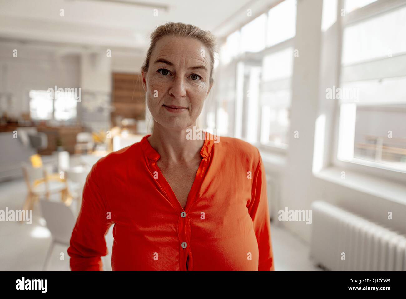 Mature woman in orange shirt hi-res stock photography and images - Alamy