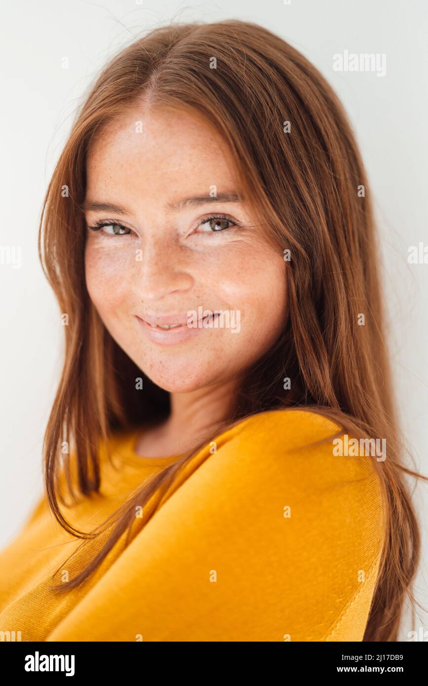 Smiling woman with brown hair in studio Stock Photo