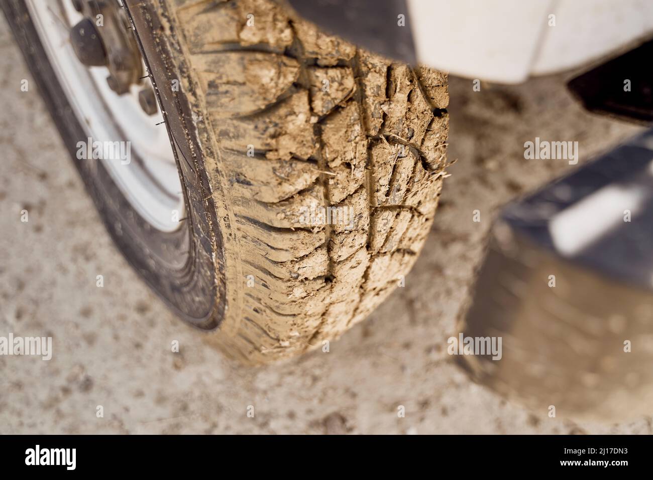 Muddy car tire on sunny day Stock Photo