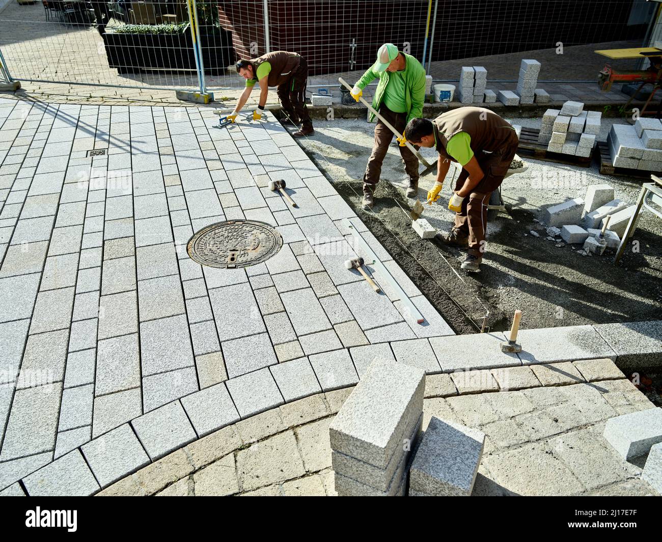 Pavers working on footpath to install paving stones Stock Photo