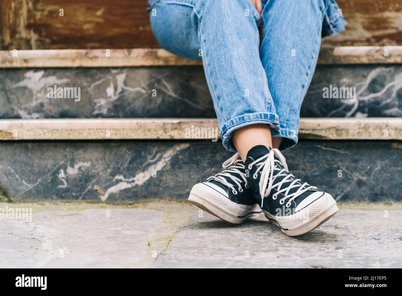 Woman with canvas shoes on footpath Stock Photo - Alamy