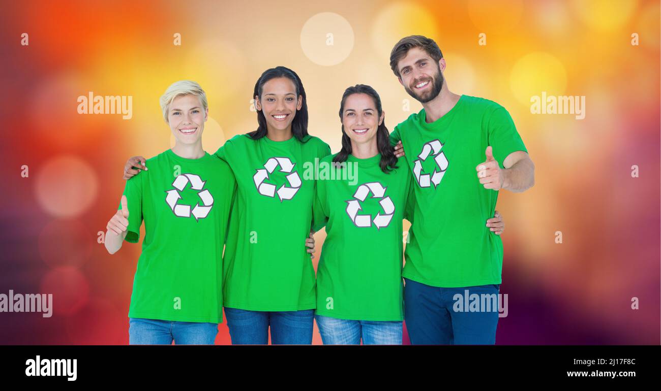 Portrait of diverse volunteers wearing recycle t-shirts against spots of light in background Stock Photo