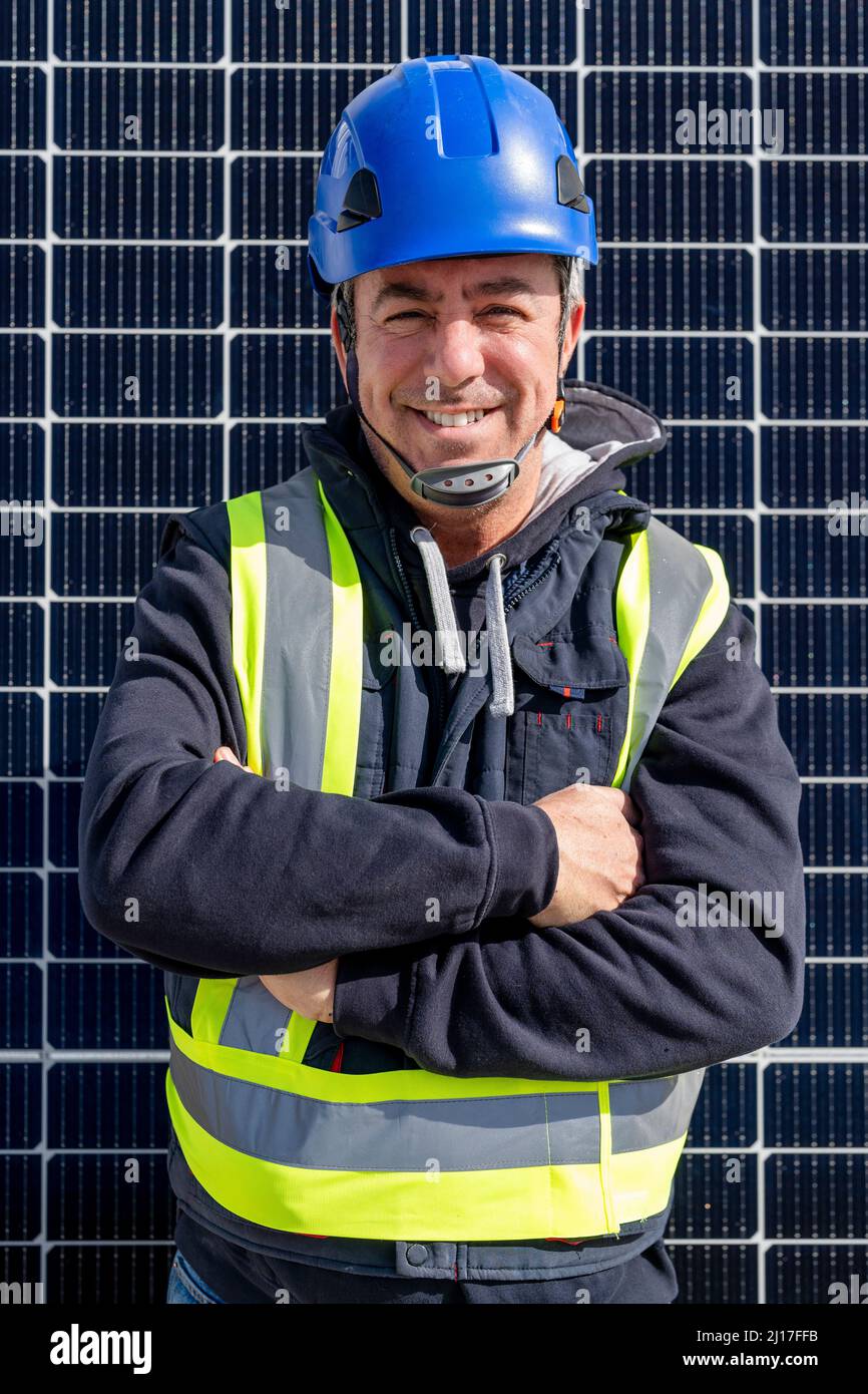 Smiling Engineer Smiling engineer with arms crossed in front of solar panel Stock Photo ...