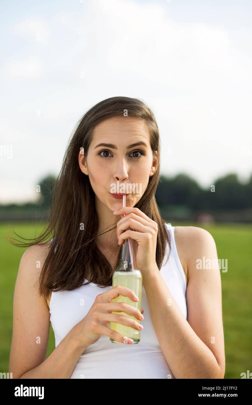 Young woman drinking lemonade juice in nature Stock Photo Alamy
