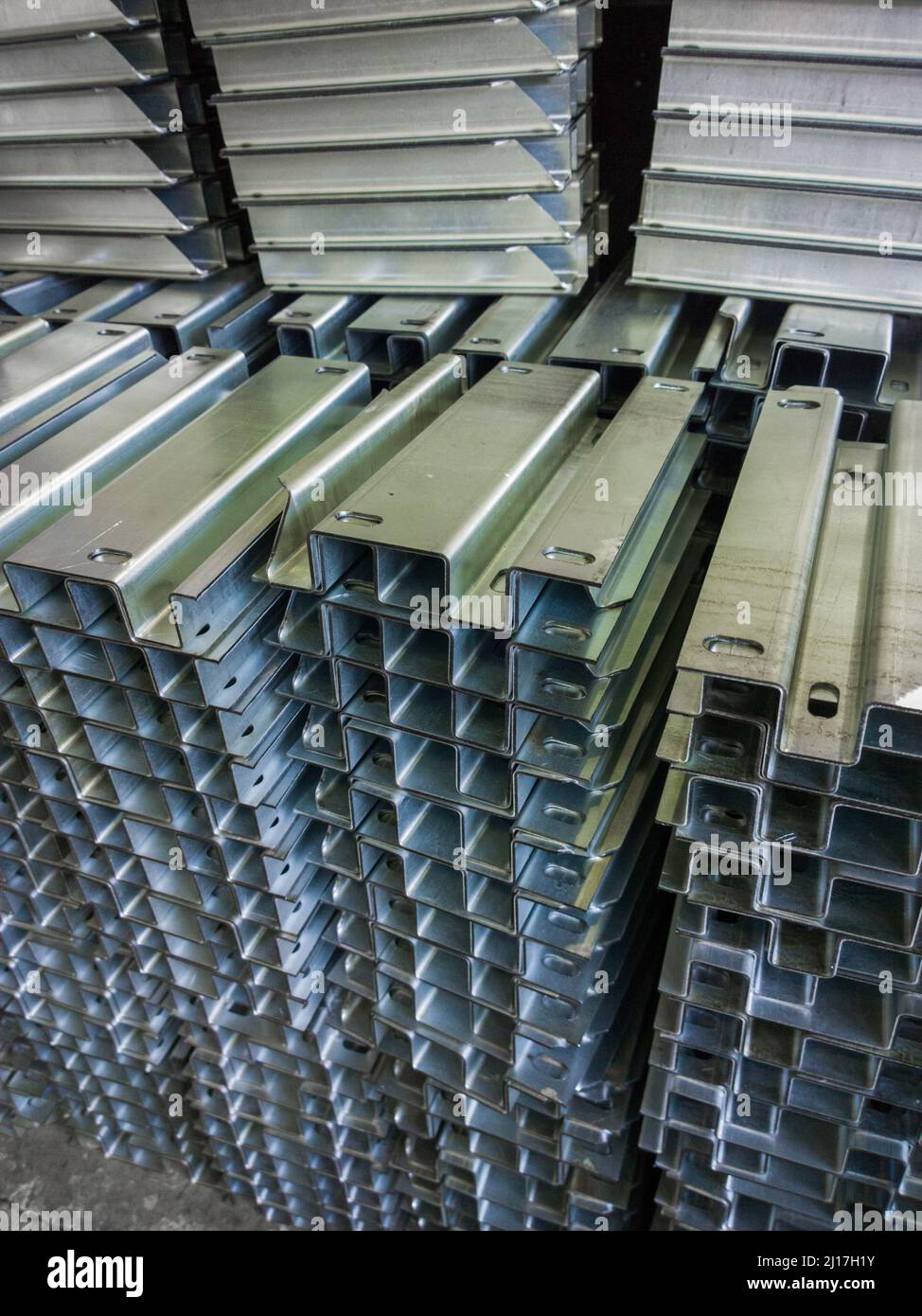 full frame view on stacks of profile bent sheet metal parts Stock Photo