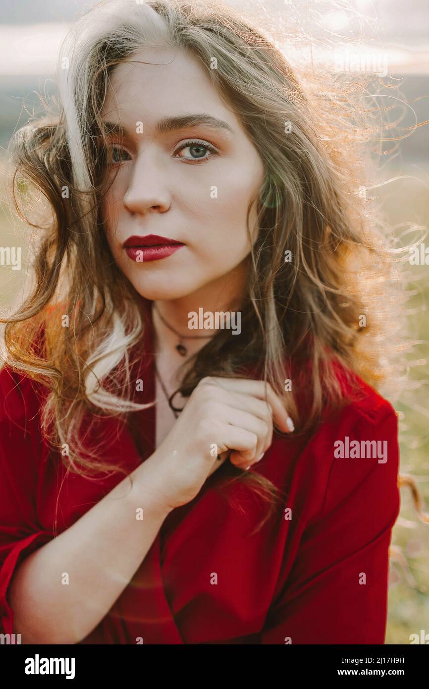 Woman in red dress standing hi-res stock photography and images - Alamy