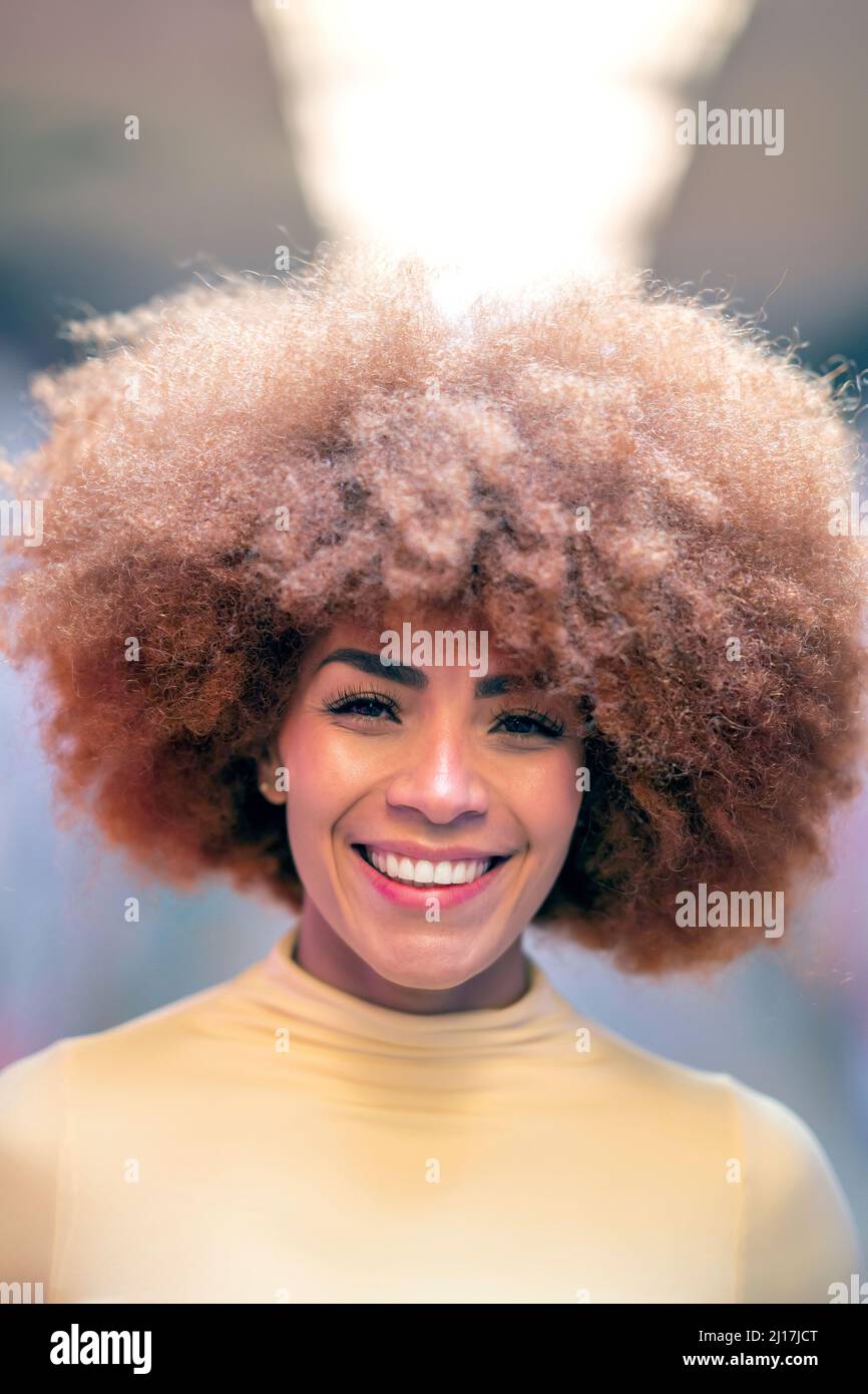Happy woman with redhead Afro hairstyle Stock Photo
