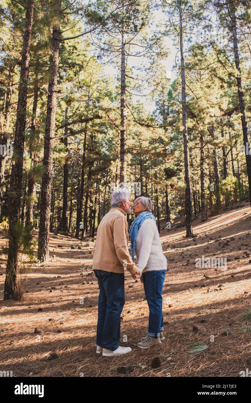 Senior couple kissing each other in forest Stock Photo