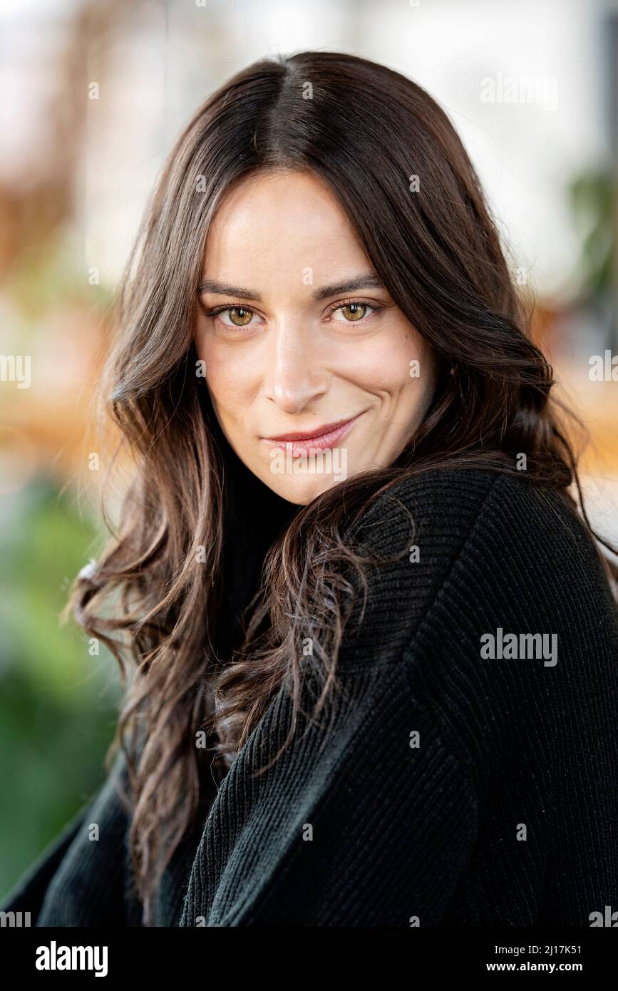 Beautiful woman with long brown hair smirking Stock Photo