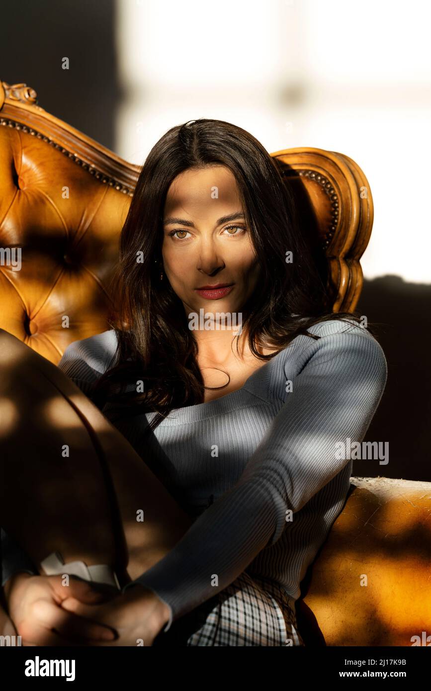 Woman sitting sofa hi-res stock photography and images - Alamy