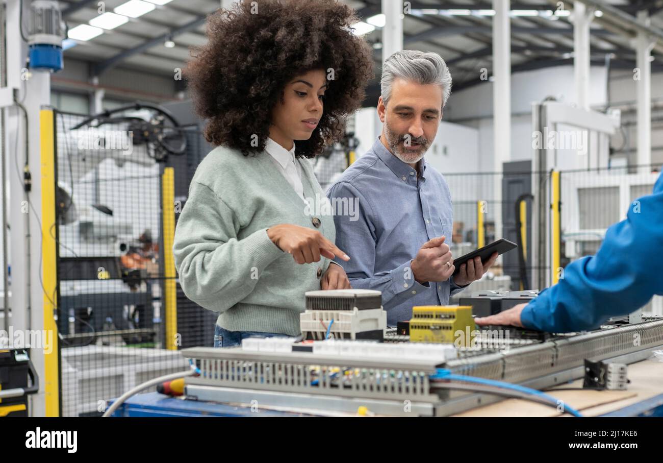 Engineer technicians discussing machine hi-res stock photography and ...