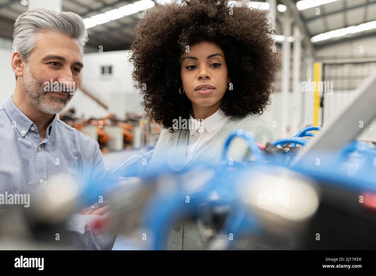 Engineer with developer in factory Stock Photo