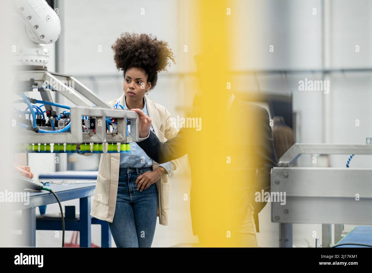 Developers analyzing machine in factory Stock Photo